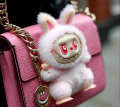 Pink labubu on a fashion bag by Coolarts223 on DeviantArt, CC BY 3.0